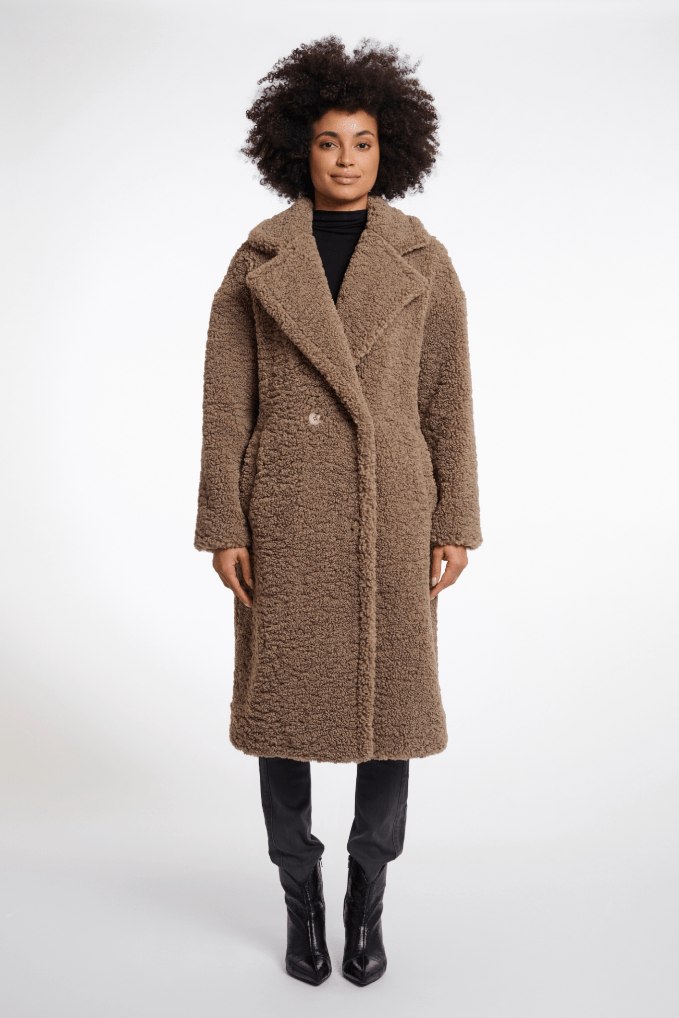 Woman wearing a brown coat on a white background