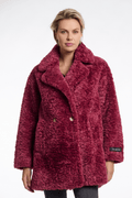 Woman wearing a red textured coat with a brand logo on a white background