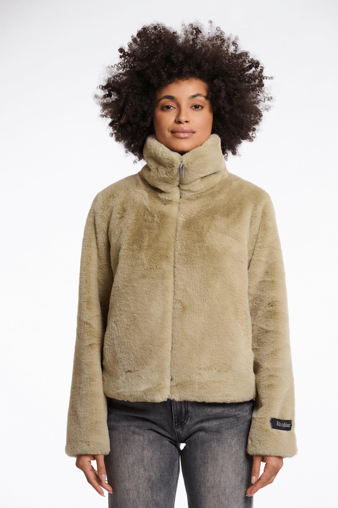 Person wearing a beige fleece jacket on a white background