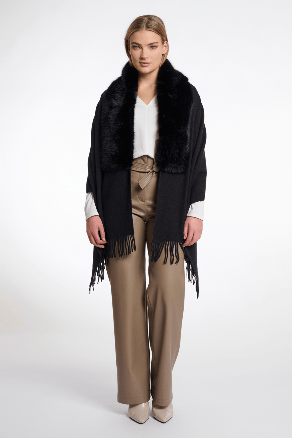 Woman wearing a black fringed scarf with a white background