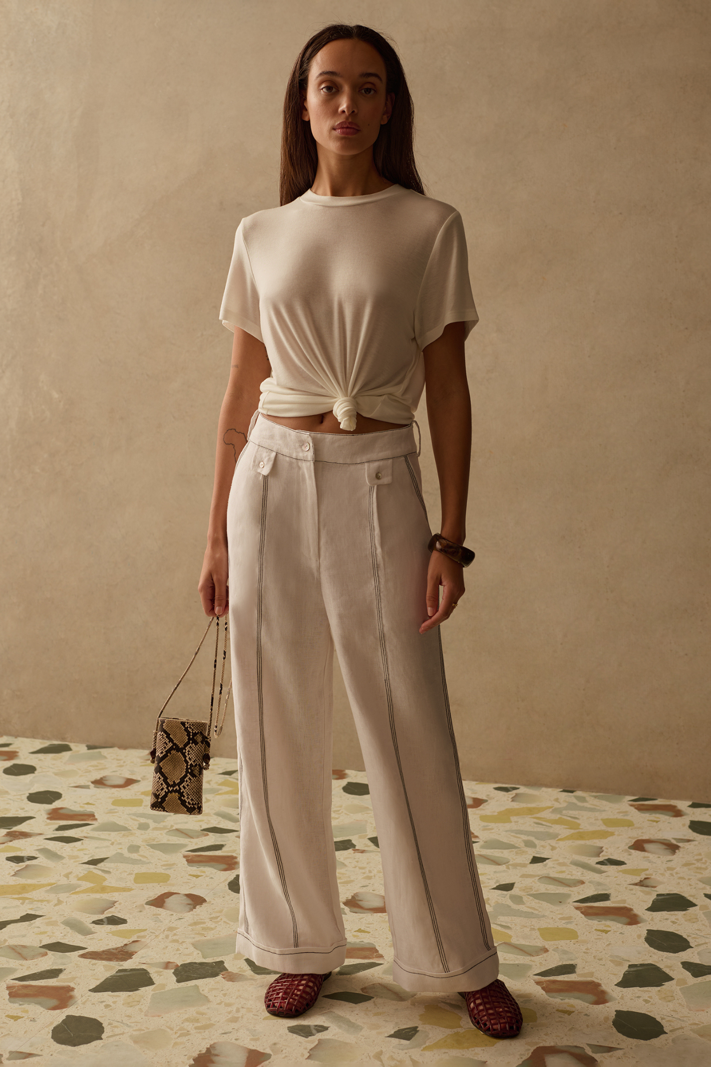 Sancia Jairo Trousers in ivory with wide leg silhouette and contrast stitching. Lightweight cupro fabric. Shop now at Dotique.