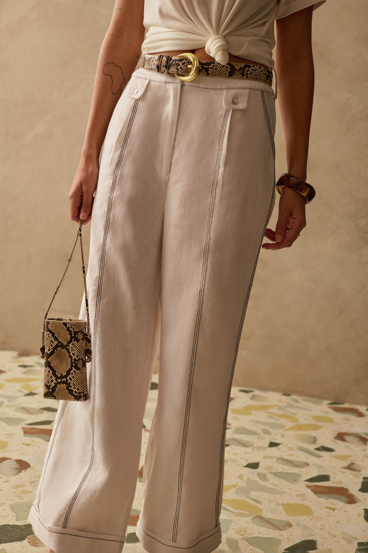 Sancia Jairo Trousers in ivory with wide leg silhouette and contrast stitching. Lightweight cupro fabric. Shop now at Dotique.