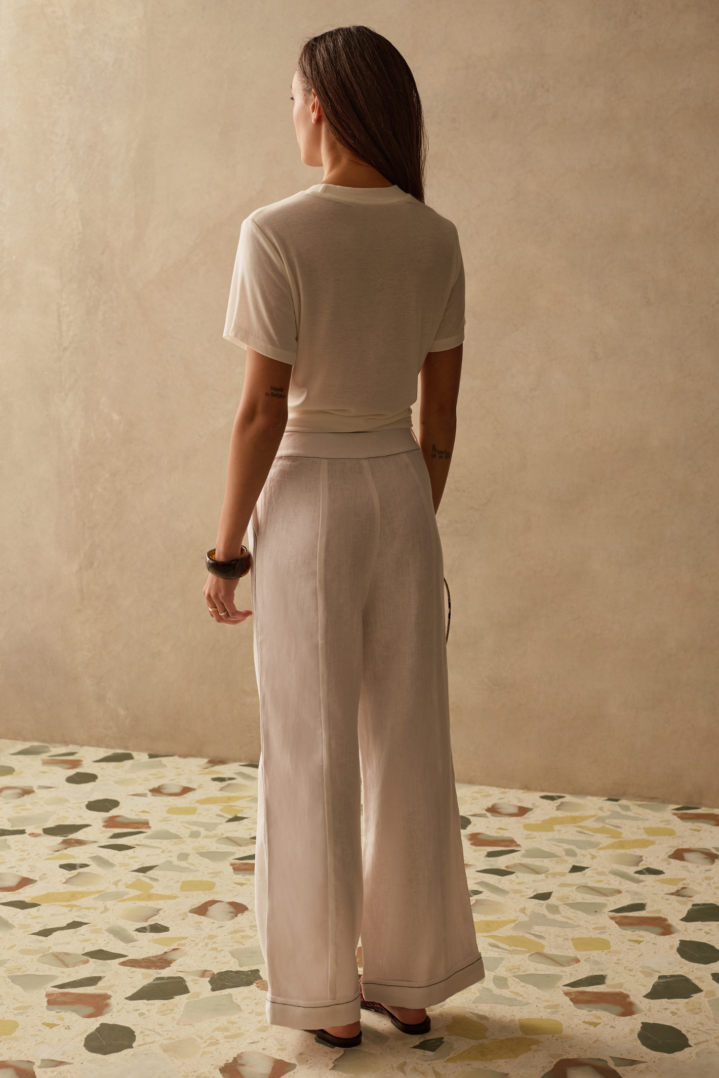 Sancia Jairo Trousers in ivory with wide leg silhouette and contrast stitching. Lightweight cupro fabric. Shop now at Dotique.