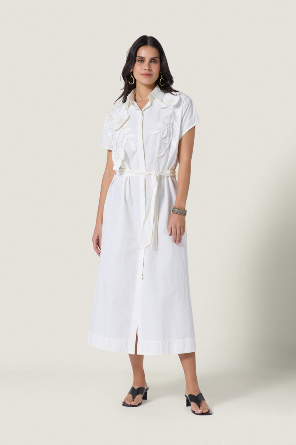 Woman wearing Scarlett Poppies Saelina Dress Papyrus in white with floral details, shop Scarlett Poppies at Dotique.