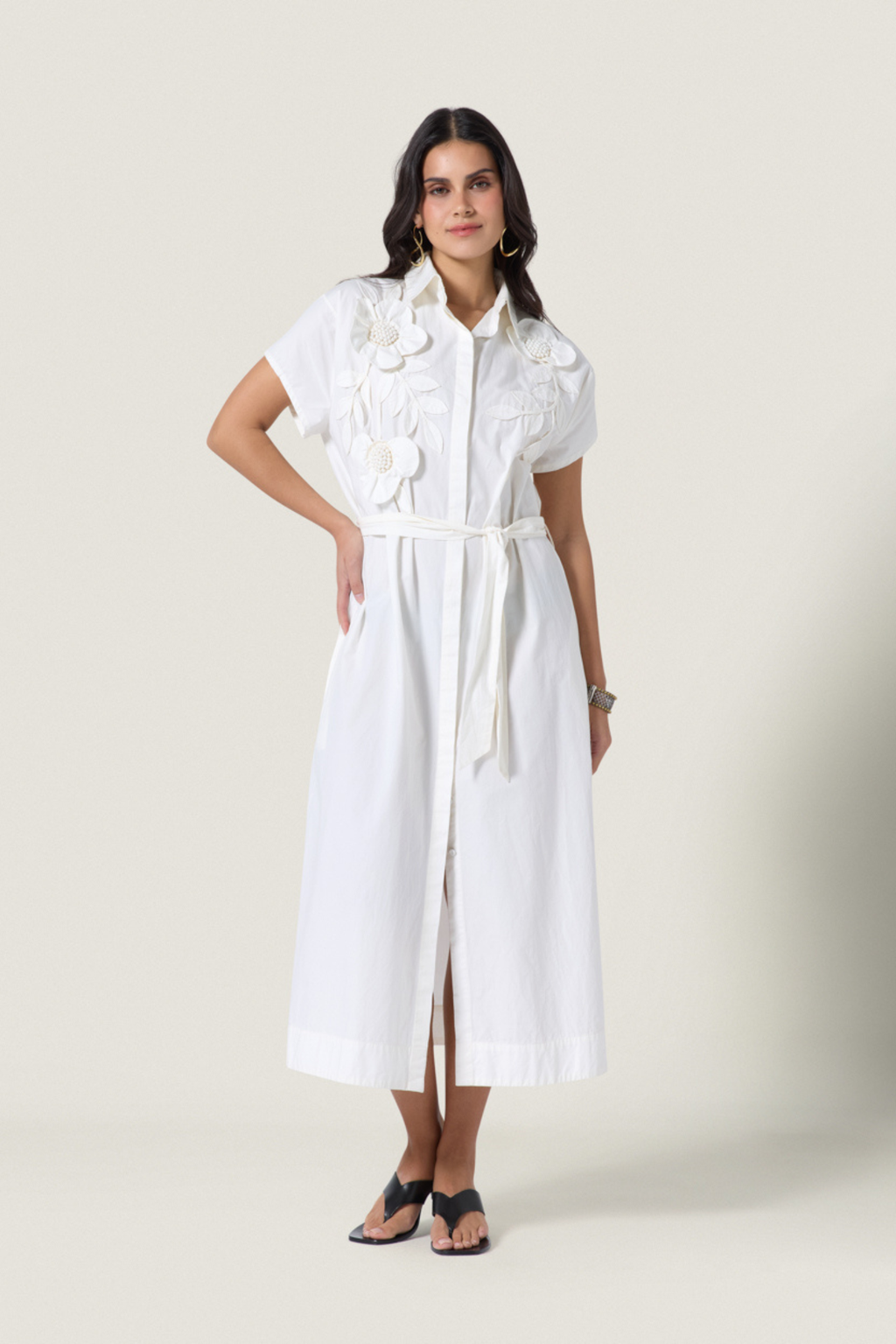 Woman wearing white Scarlett Poppies Saelina Dress Papyrus with floral details, shop Scarlett Poppies at Dotique.