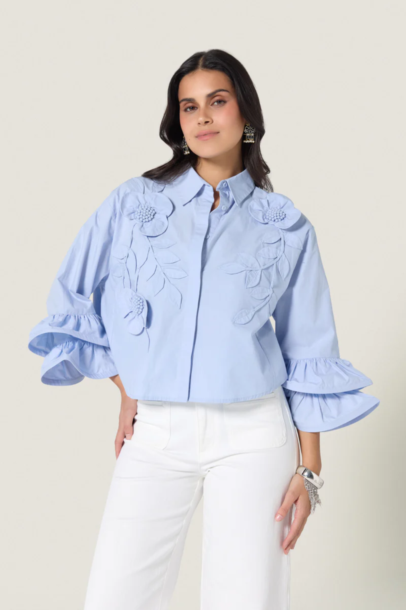 Woman wearing Scarlett Poppies Siena Top Windsurfer Blue blouse with floral applique, shop Scarlett Poppies at Dotique.