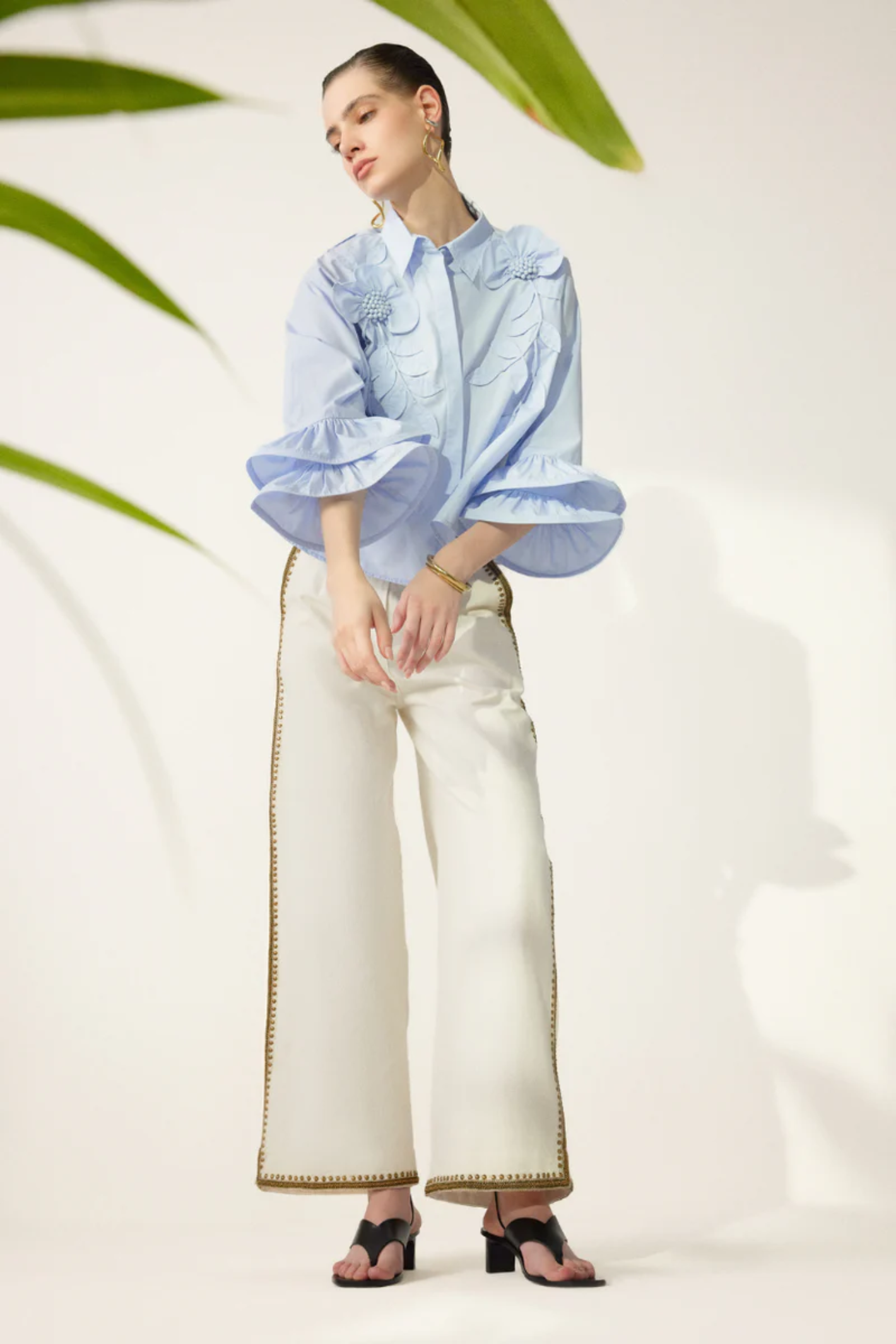 Model wearing Scarlett Poppies Siena Top Windsurfer Blue with white pants, shop Scarlett Poppies at Dotique for elegant styles.