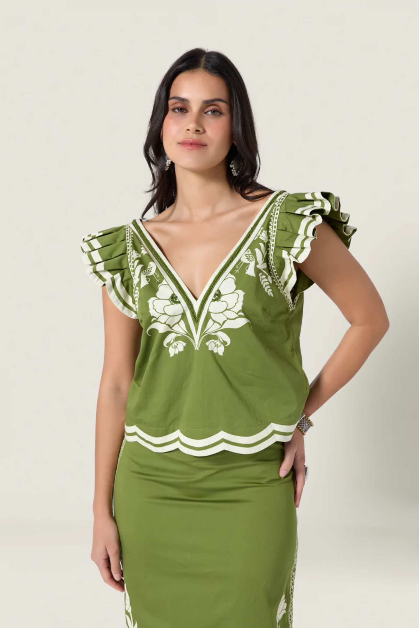 Model wearing Scarlett Poppies Vittore Top Calla Green/Papyrus by Scarlett Poppies, shop Scarlett Poppies at Dotique