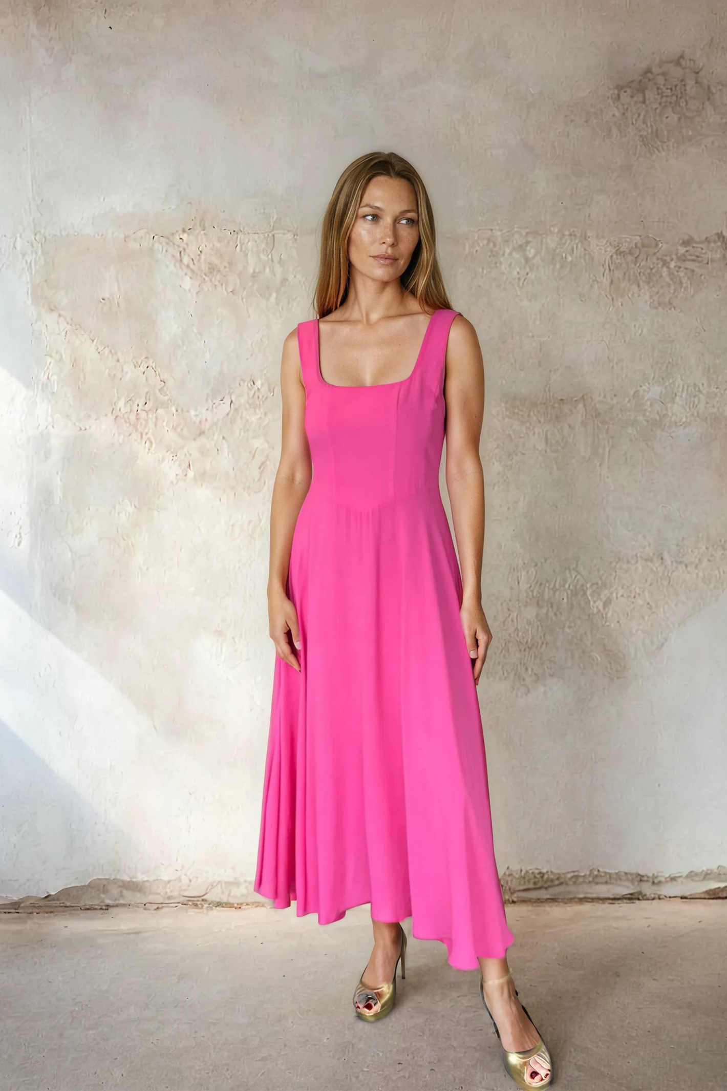 Model wearing Sirens Sleeveless Pink Bella Dress with a square neckline and flowing silhouette by Sirens. Shop Sirens at Dotique.