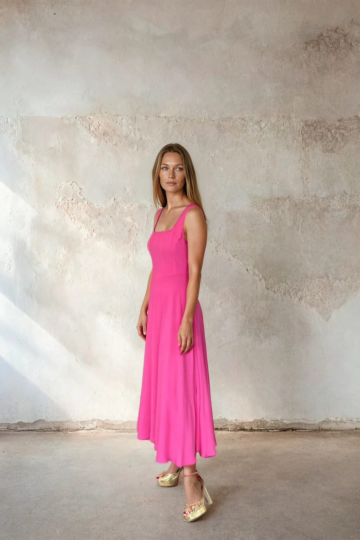 Model wearing Sirens Sleeveless Pink Bella Dress with a square neckline and flowing silhouette by Sirens. Shop Sirens at Dotique.