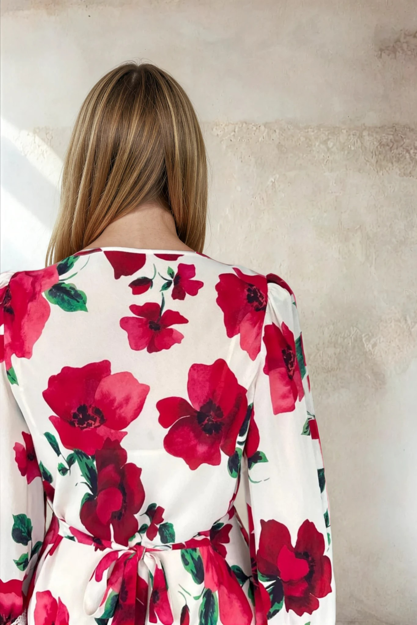 Back view of a woman wearing Sirens Violet Cream Poppy Dress with vibrant red floral print and tied waist by Sirens. Shop Sirens at Dotique.