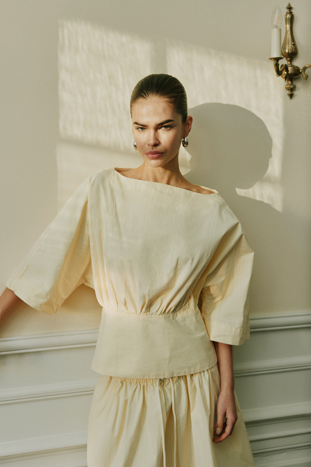 Model wearing Sofie Schnoor S261311 Mikkasw Boat-Neck Blouse – Light Yellow, shop Sofie Schnoor at Dotique gallery 1