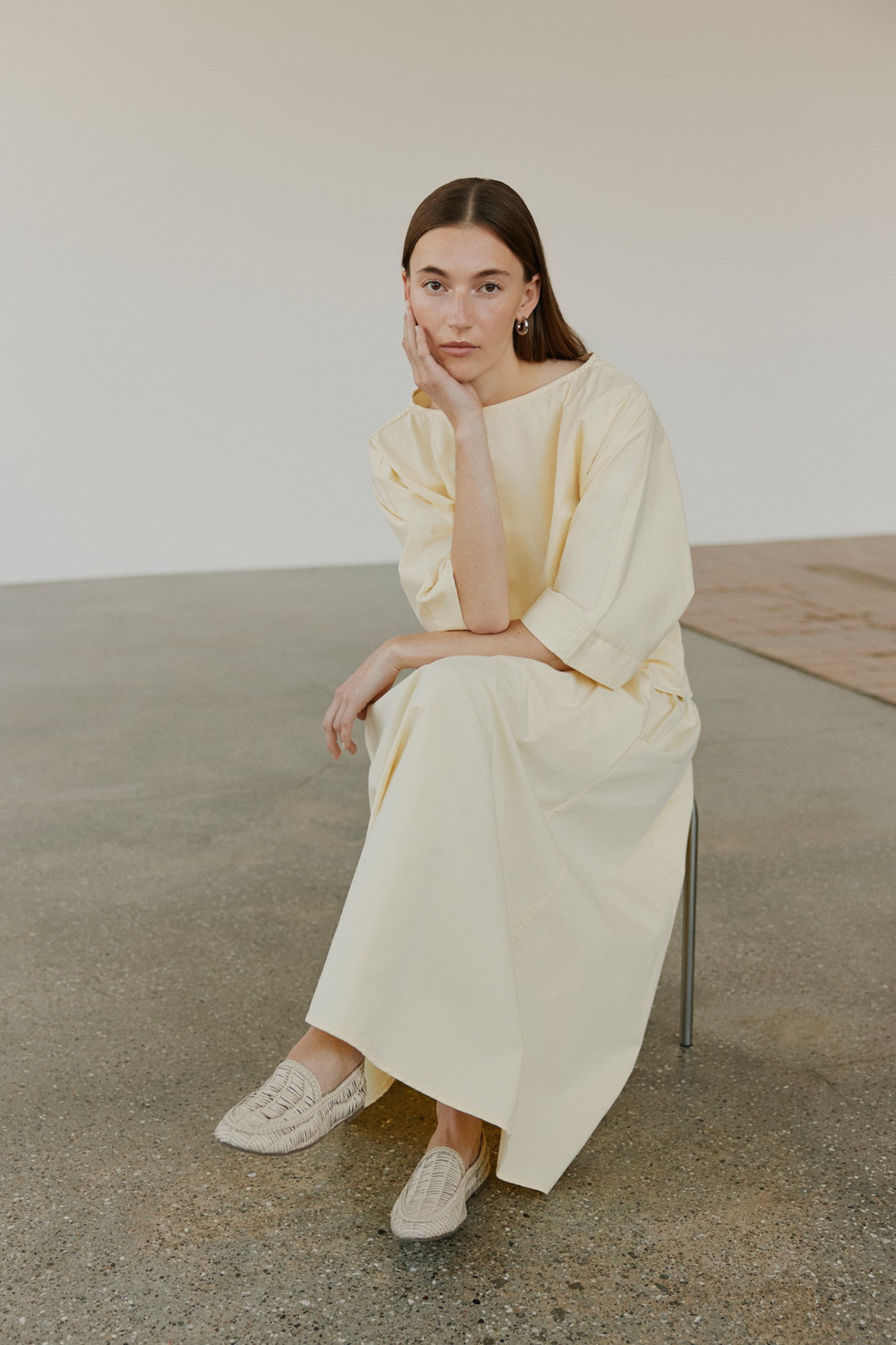 Model seated wearing Sofie Schnoor S261312 Juneausw Midi Skirt – Light Yellow from Sofie Schnoor, shop Sofie Schnoor at Dotique gallery 1