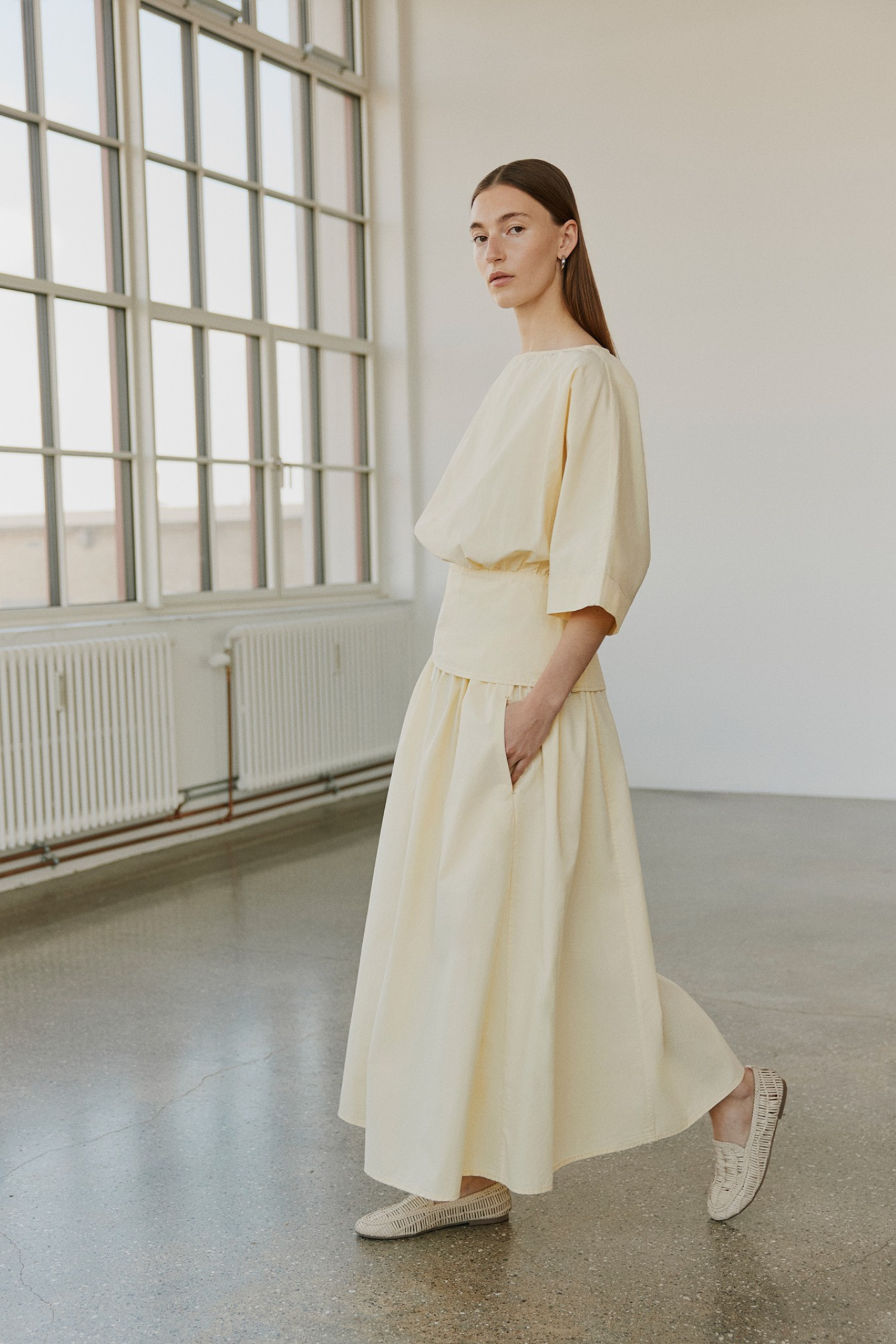 Model standing wearing Sofie Schnoor S261312 Juneausw Midi Skirt – Light Yellow by Sofie Schnoor, shop Sofie Schnoor at Dotique gallery 1