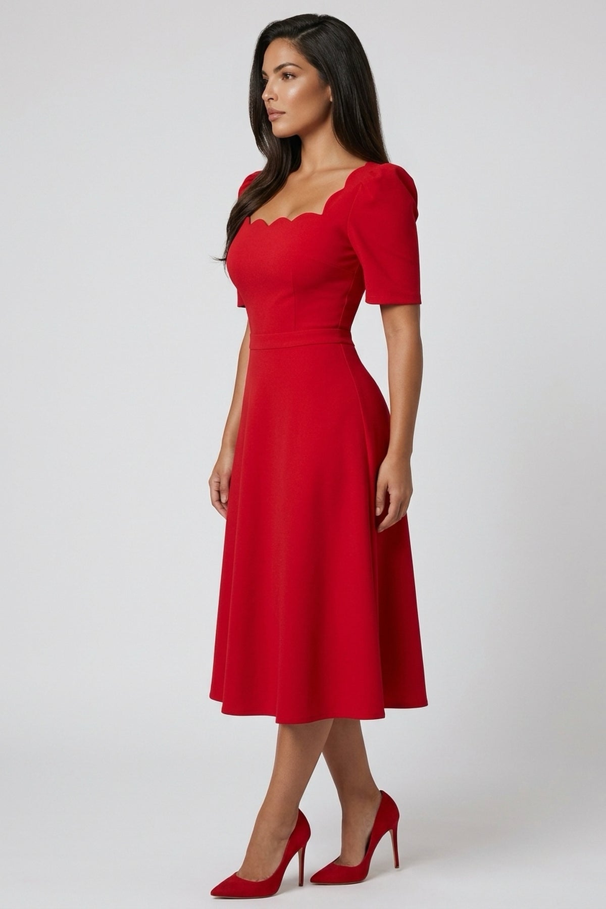 Side view of a model wearing The 8th Sign Livia scallop midi dress in red