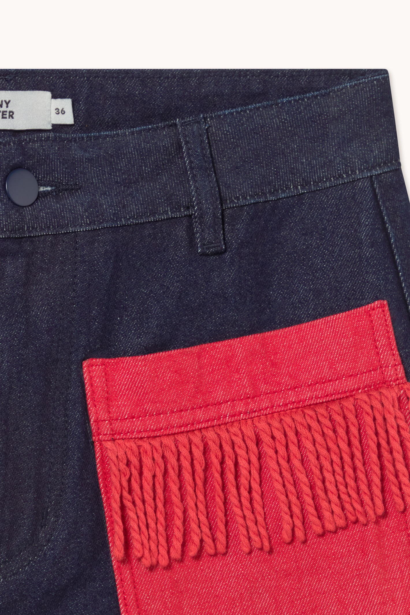Shop The Tiny Big Sister wide-leg denim trousers in indigo with contrast red fringed pockets. 100% Cotton statement denim at Dotique.