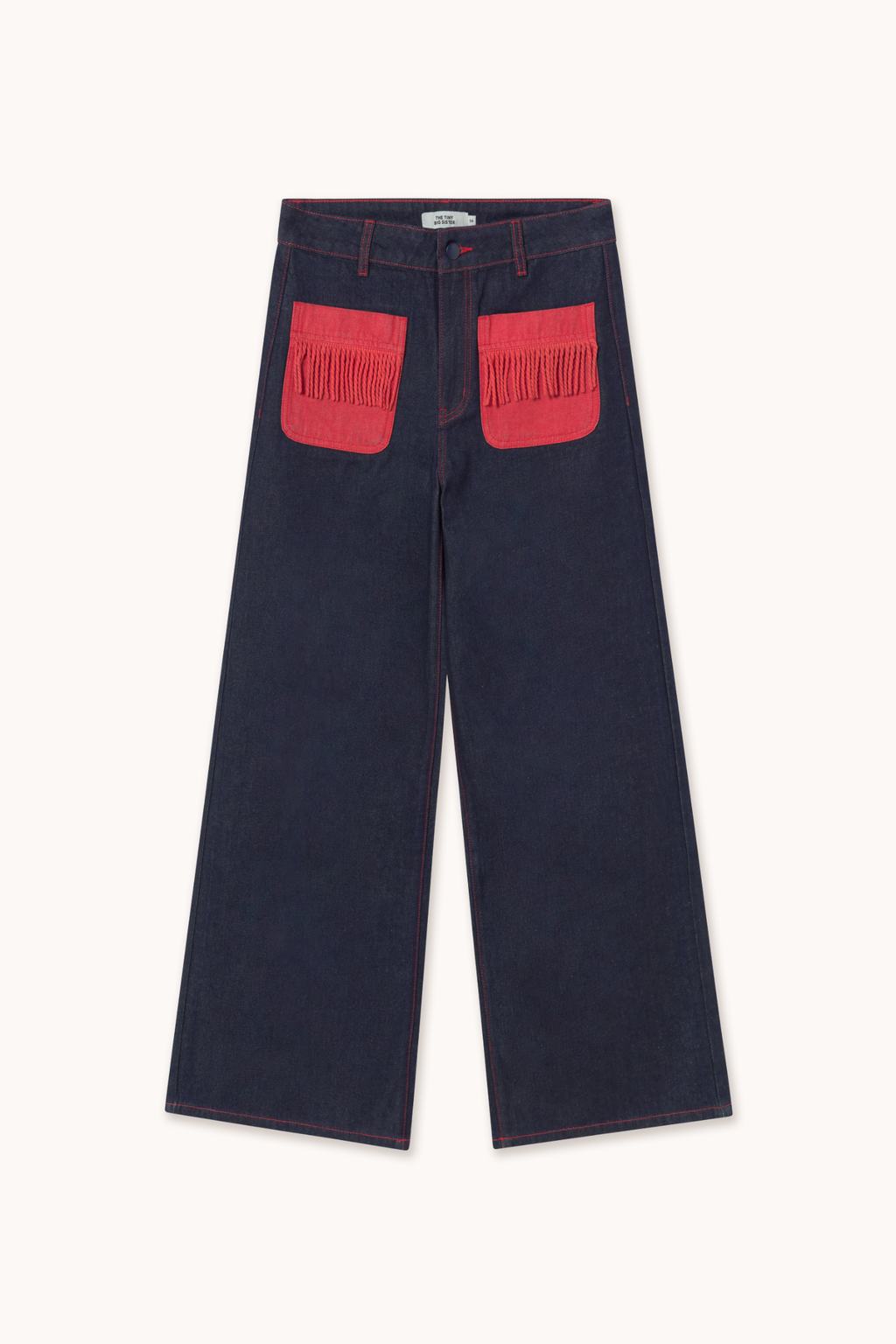 Shop The Tiny Big Sister wide-leg denim trousers in indigo with contrast red fringed pockets. 100% Cotton statement denim at Dotique.