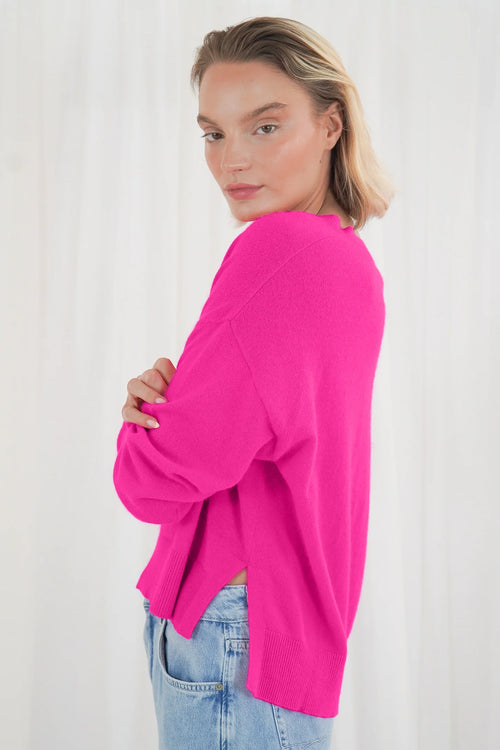 Add a pop of colour with the TWNS The Label Boulder Neon Pink V-Neck Jumper. Crafted from a luxuriously soft raccoon blend with a relaxed fit and flattering V-neck. Shop TWNS The Label  at Dotique.