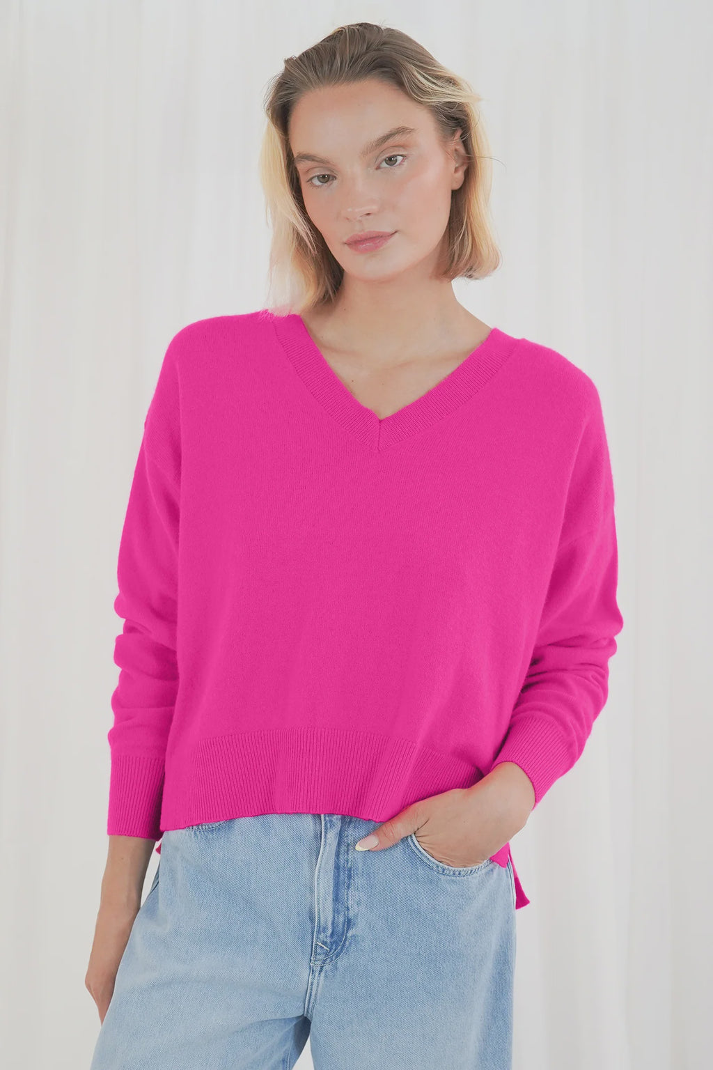 Add a pop of colour with the TWNS The Label Boulder Neon Pink V-Neck Jumper. Crafted from a luxuriously soft raccoon blend with a relaxed fit and flattering V-neck. Shop TWNS The Label  at Dotique.