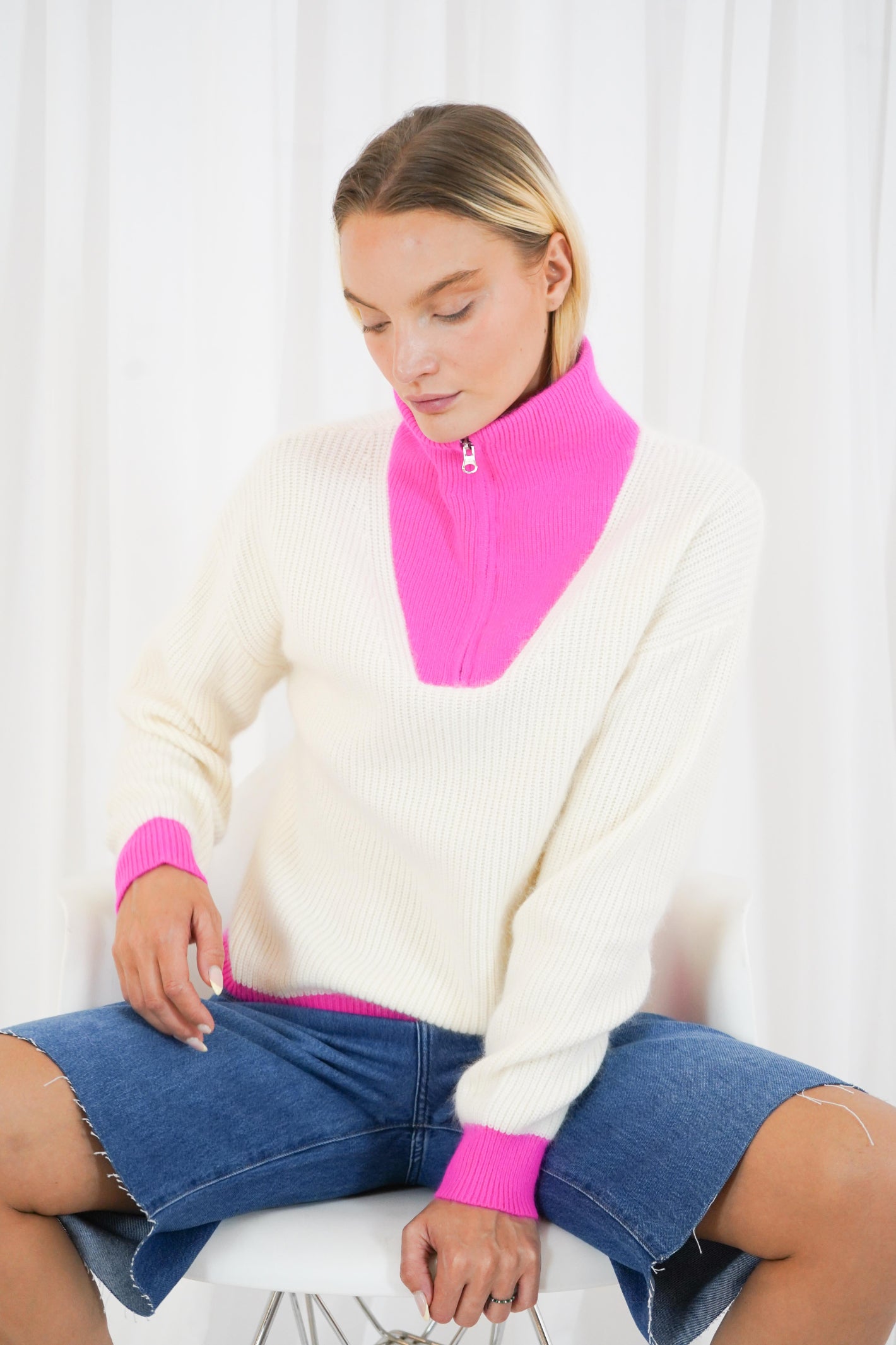 TWNS The Label Breckenridge II off white and neon pink trucker neck jumper with silver zip fastening. Shop now at Dotique.