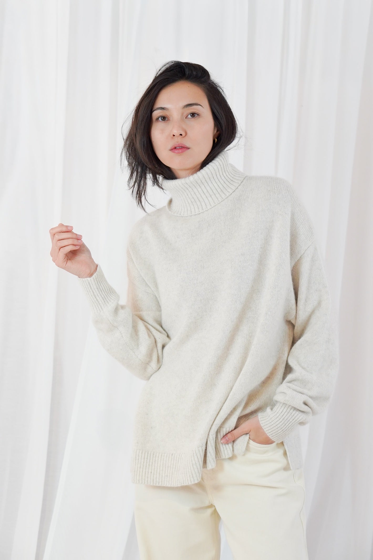 TWNS The Label Greeley mottled beige turtleneck jumper with a relaxed fit and long sleeves.