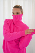 TWNS The Label Greeley neon pink turtleneck jumper with a relaxed fit and long sleeves. Shop at Dotique.