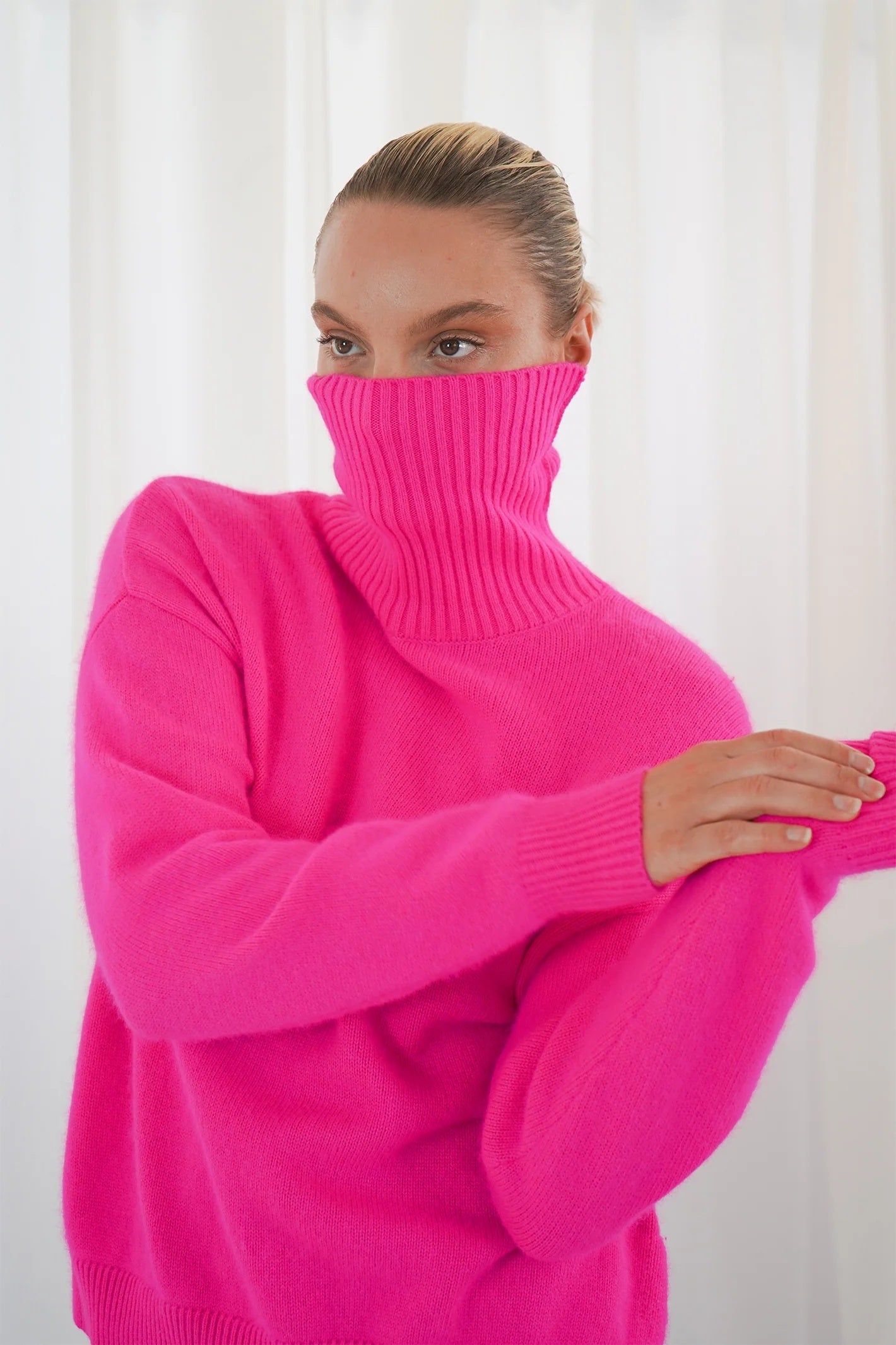 TWNS The Label Greeley neon pink turtleneck jumper with a relaxed fit and long sleeves. Shop at Dotique.