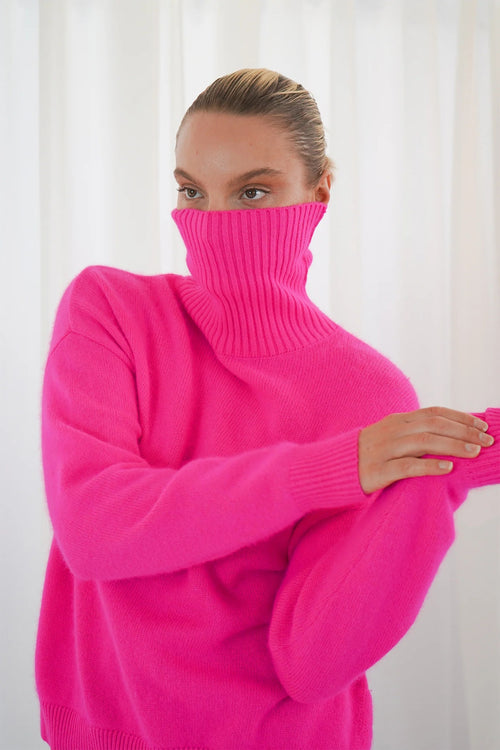TWNS The Label Greeley neon pink turtleneck jumper with a relaxed fit and long sleeves. Shop at Dotique.