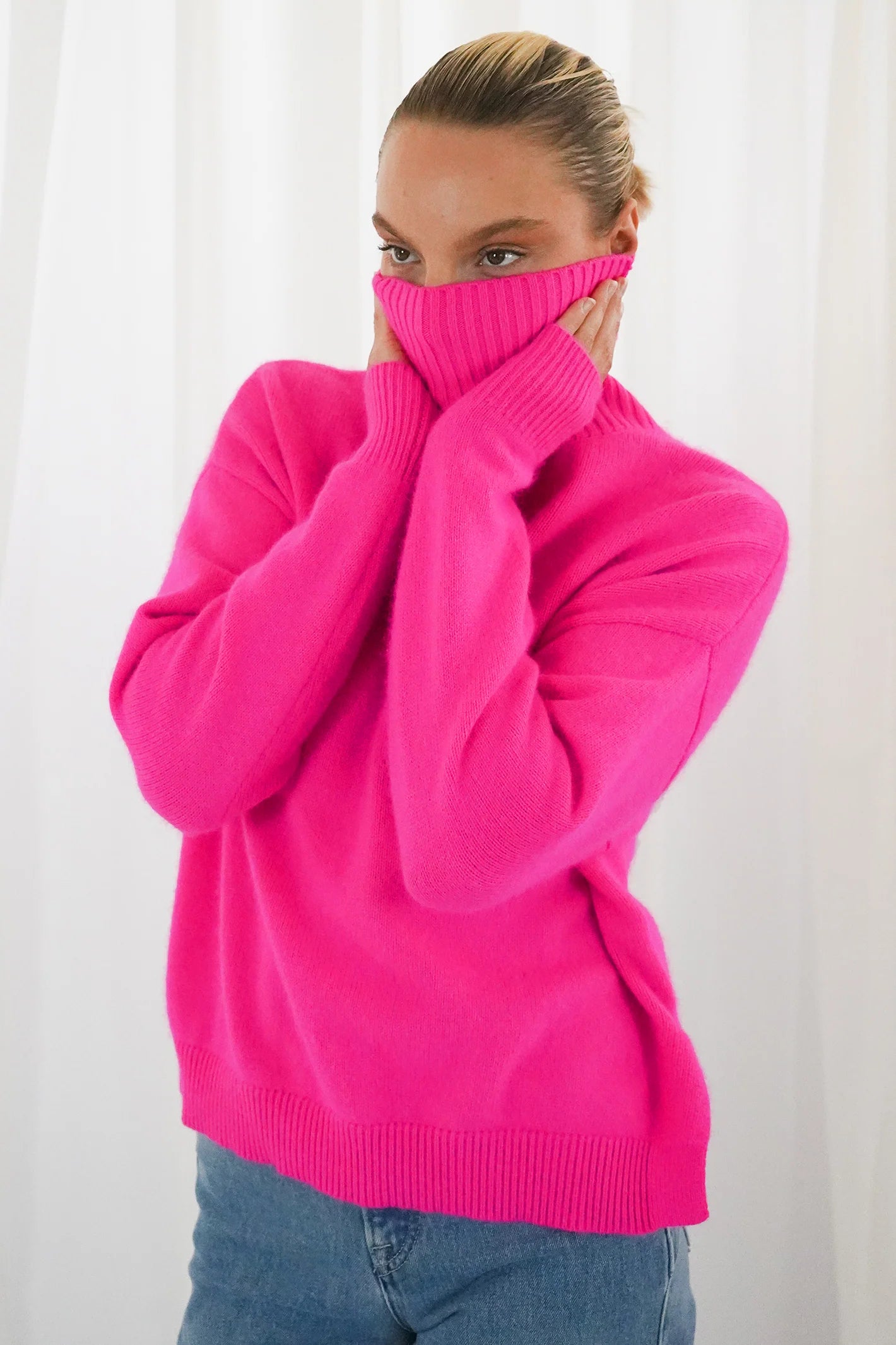 TWNS The Label Greeley neon pink turtleneck jumper with a relaxed fit and long sleeves. Shop at Dotique.