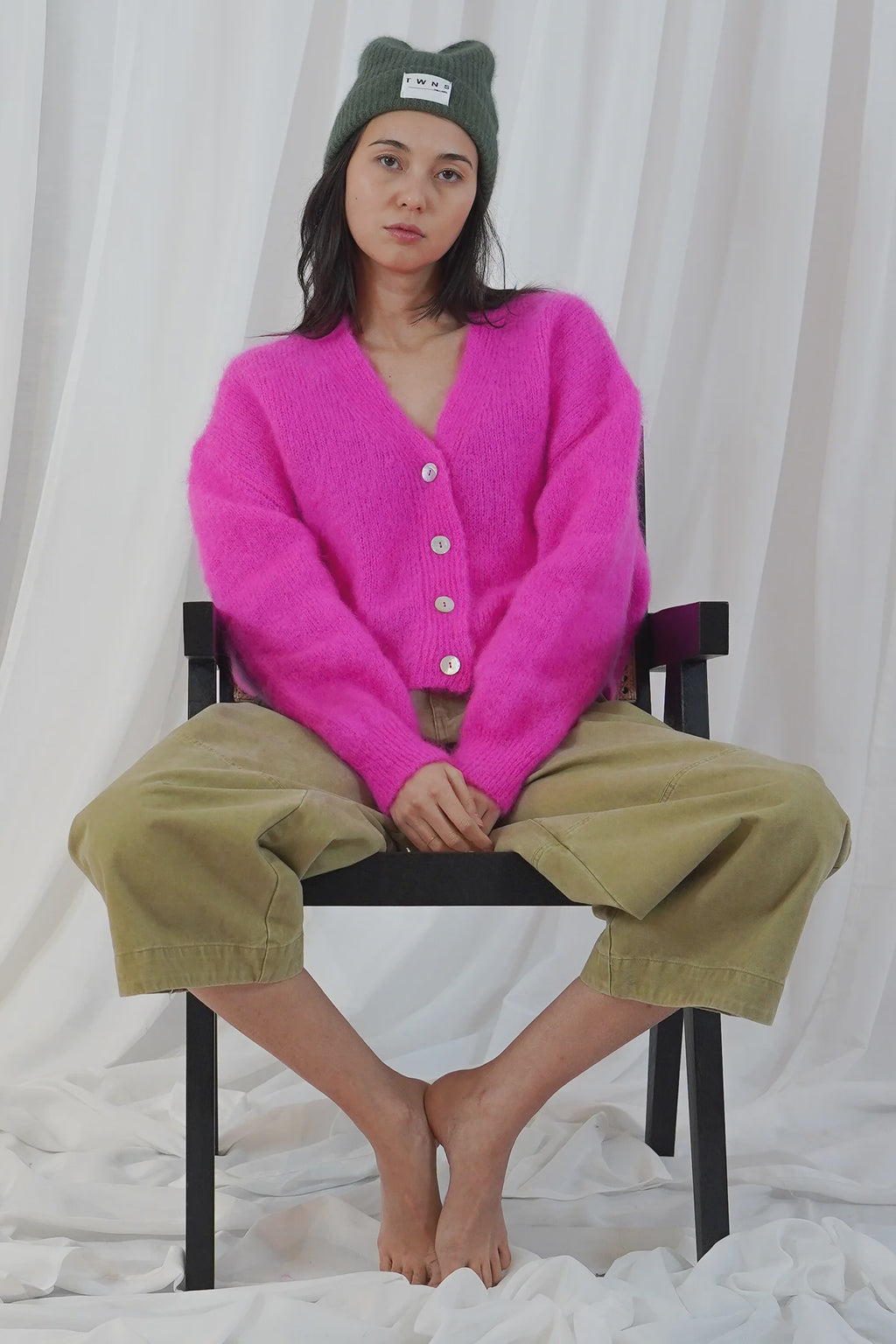 TWNS The Label Malia neon pink buttoned V-neck cardigan with long sleeves and relaxed fit.