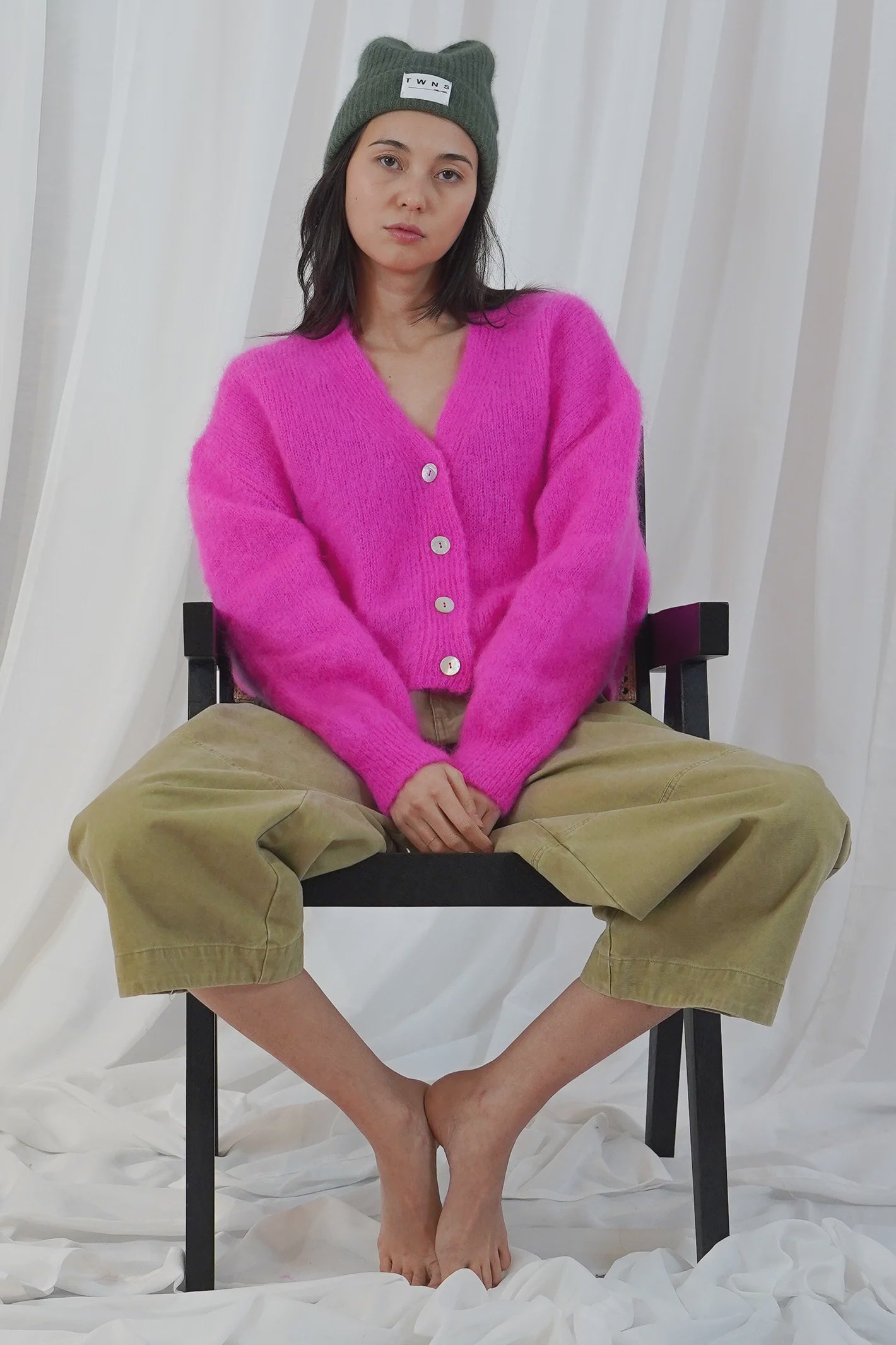 TWNS The Label Malia neon pink buttoned V-neck cardigan with long sleeves and relaxed fit.