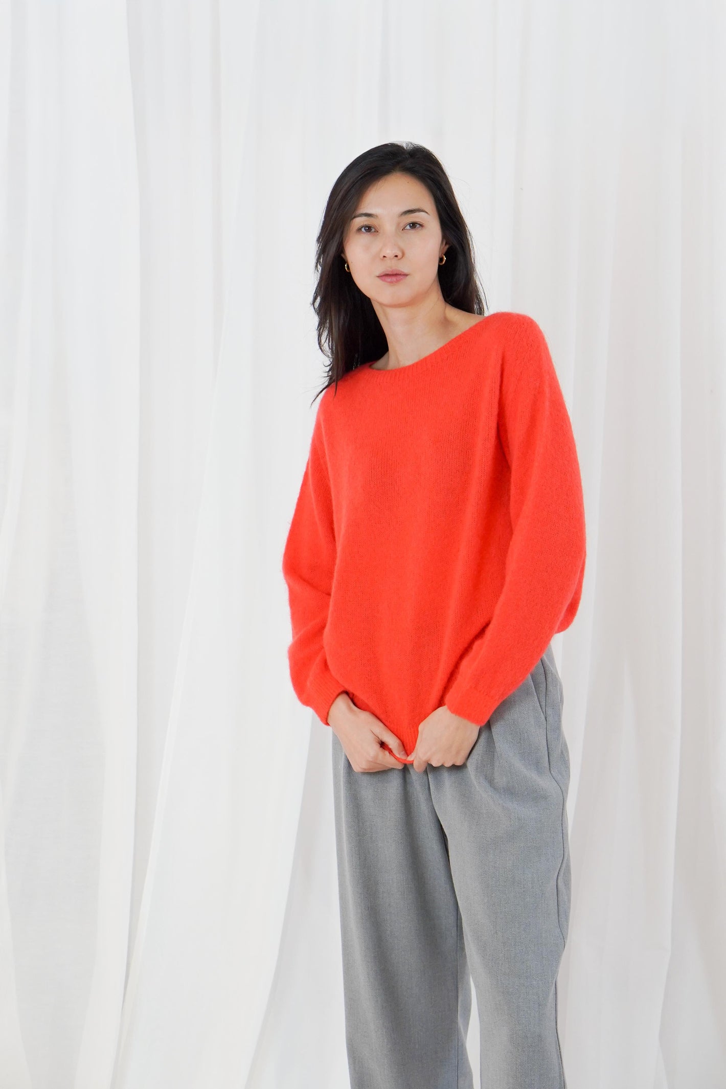 TWNS The Label Sanibel Fire boat neck jumper in a vibrant coral-red with a relaxed fit and long sleeves.