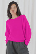 TWNS The Label Sanibel Fire boat neck jumper in a vibrant coral-red with a relaxed fit and long sleeves.