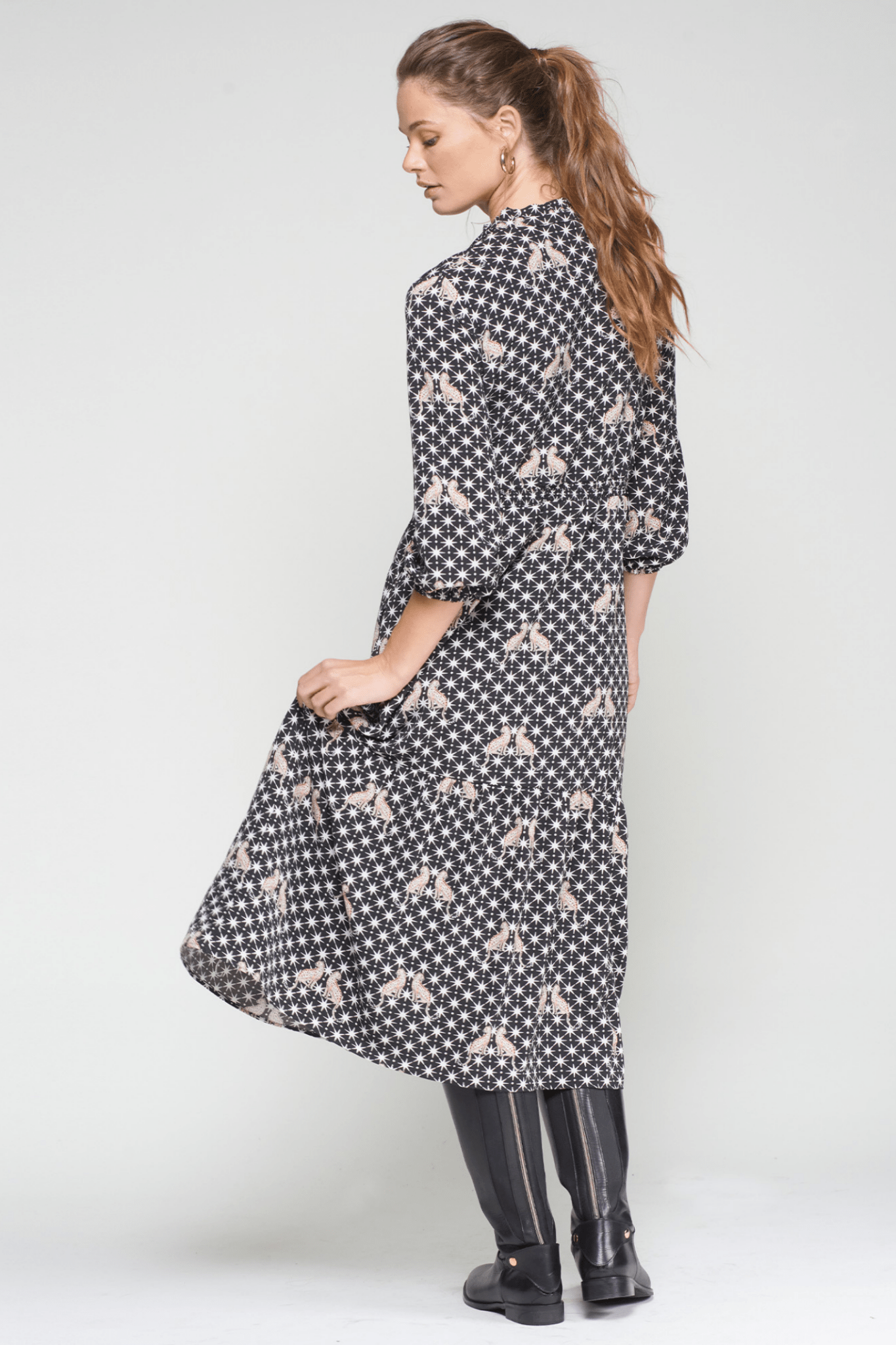 Model wearing a patterned midi dress by Vilagallo, shop Vilagallo 33005 Leopard Print Midi Dress at Dotique.