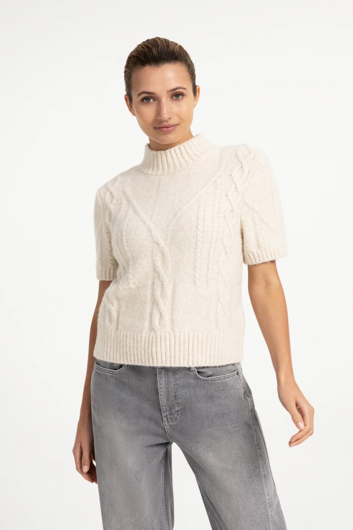Shop the YAYA Cable Knit Short Sleeve Jumper in Off White Melange at Dotique. A textured cable knit with a mock neck, short sleeves and a regular fit.